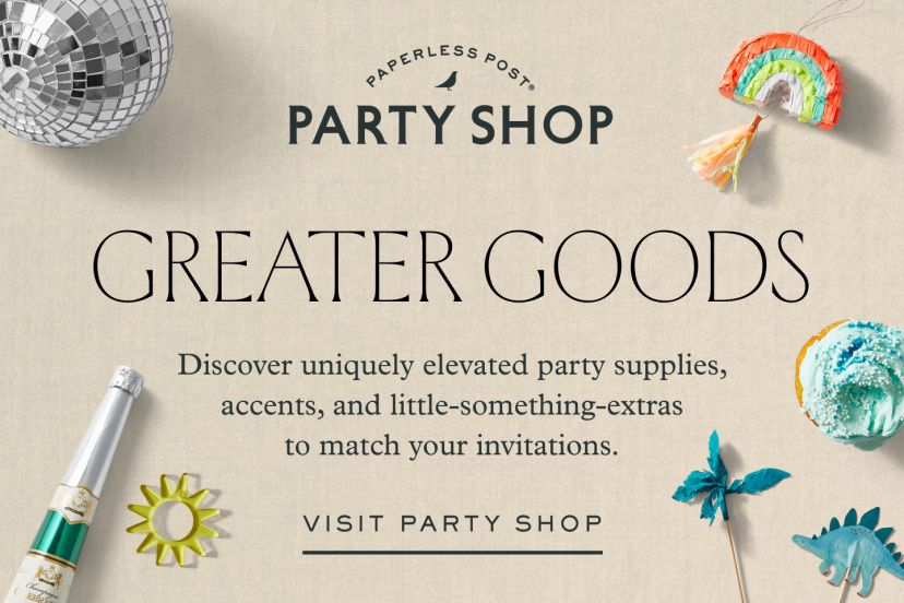 A festive flat-lay featuring Paperless Post's Party Shop banner surrounded by colorful party items, including disco balls, candles, metallic cups, napkins, a champagne popper, dinosaur and rainbow cake toppers, a number 4 sparkler, a gift bag with dinosaur illustrations, and pastel treats. The headline reads 'Greater Goods' with a subheading promoting uniquely elevated party supplies and accents.