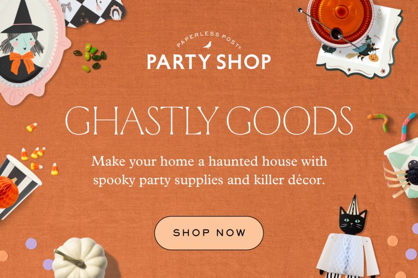A headline that reads ‘Ghastly goods’ sits below a Paperless Post Party Shop logo and above two pieces of text that read ‘Make your home a haunted house with spooky party supplies and killer décor’ and ‘Shop now’ against a horizontal textured orange backdrop decorated with Halloween props such as two papier-mache pumpkin and spider cups, a papier-mache cat wearing a party hat, two illustrations of a witch and a skeleton in ornate mirrors, a white pumpkin, gummy worms, jelly beans, candy corn, confetti, spooky napkins, a pear, a green cupcake, and a Halloween-themed cocktail.