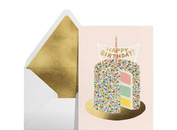 A light pink card with a rainbow cake