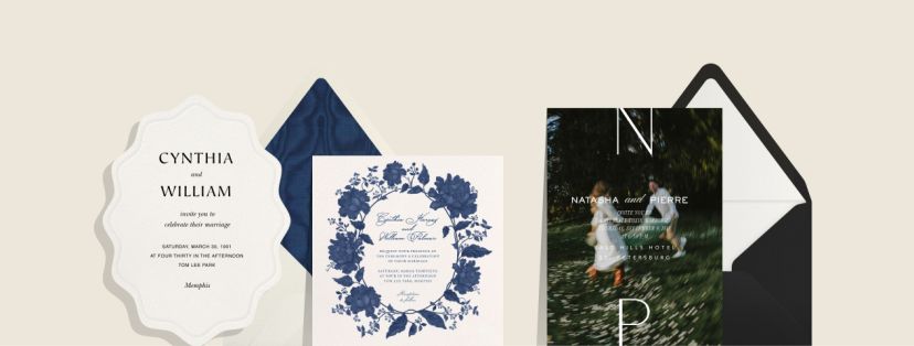 Examples of three wedding invitations on a cream background; the first an oval shape with a scallop edge featuring black text, the second with an illustrated blue floral border and cursive script paired with a cream envelope and blue moire envelope liner, the third featuring a blurry photo of a couple in a field with 'N' and 'P' initials paired with a black envelope and white envelope liner. 