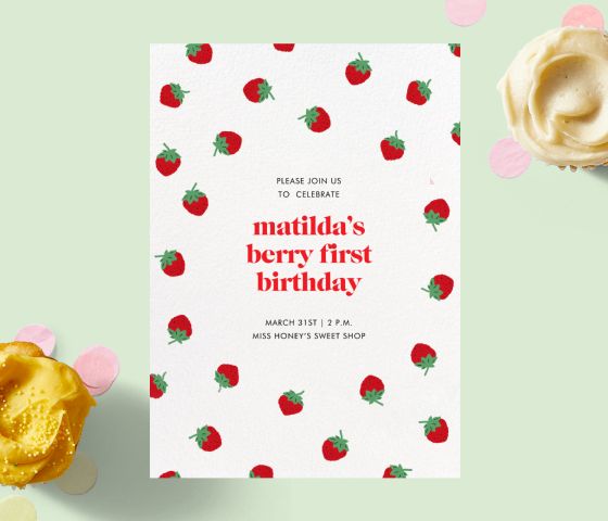 Una invitación con fresas alrededor del borde sobre un fondo verde con magdalenas.