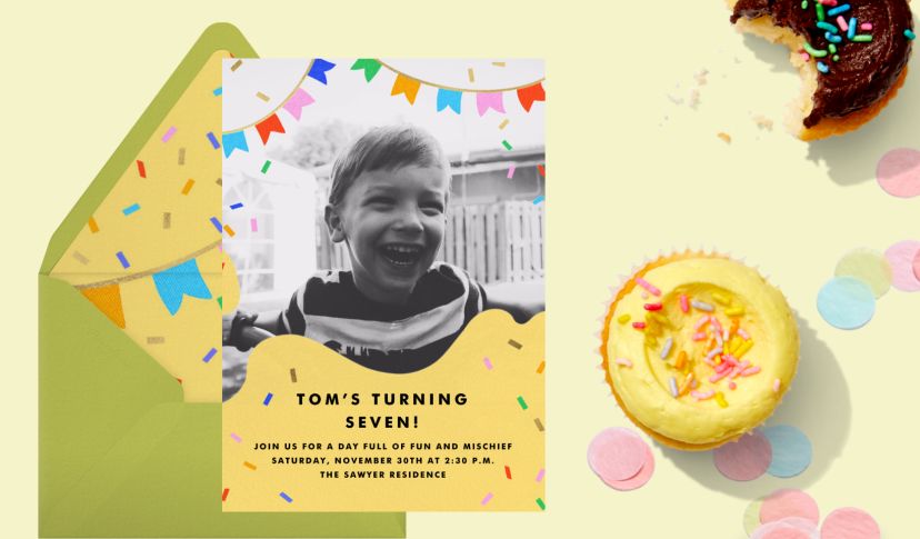 Bright yellow kids’ birthday invitation with confetti accents and a black-and-white photo of a smiling child, styled with a green envelope and sprinkled cupcake.