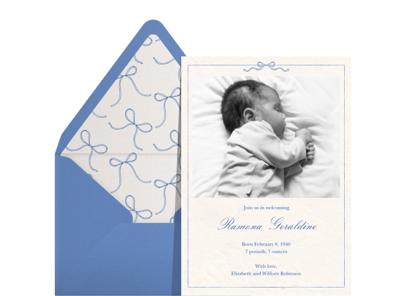 Four birth announcement cards with matching envelopes on a light blue backdrop: A photo card with a floral border, a white card with a pink ribbon border, A card with three different photos, and a black-and-white photo card with blue text and a blue ribbon border. 