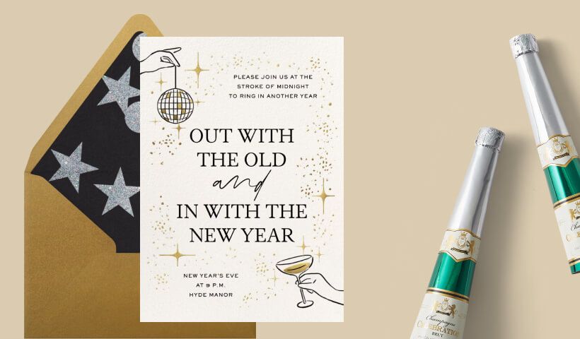 An invitation to a New Year’s Eve party with sparkly accents and drawn hands holding a disco ball and martini glass, set on a gold envelope with a black starry liner, on a tan background with two bottles of champagne. 