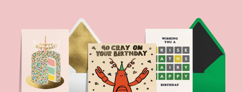 A pink backdrop set with three birthday cards: a pink card with a colorful birthday cake with sprinkles and a candle, a card featuring a red cartoon crayfish and text reading 'GO CRAY ON YOUR BIRTHDAY',  and a card featuring a word-puzzle graphic to spell out 'HAPPY' along with a birthday wish. 