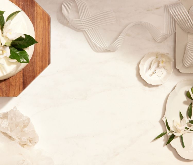 A wooden backdrop set with a platter of fruit and a candle. 